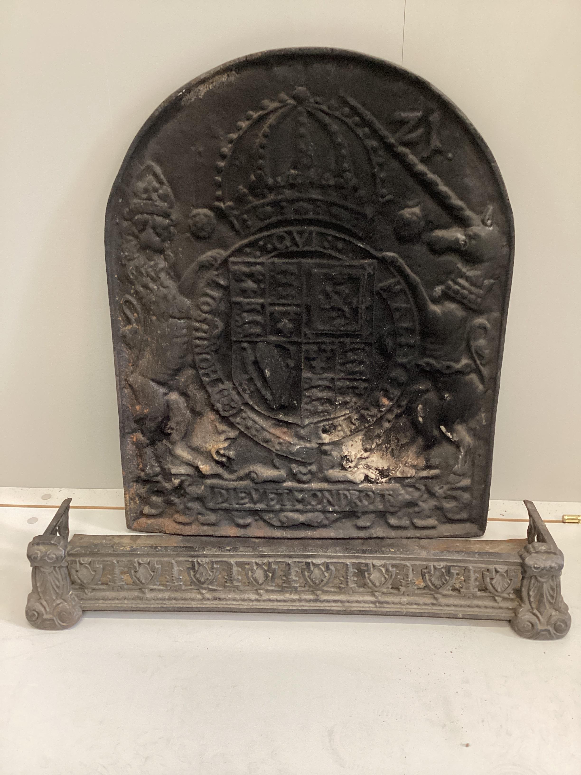 A Victorian cast iron Royal Coat of Arms fireback, width 54cm, height 68cm together with a small Victorian cast iron fender